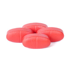 Red oral medication tablets close up on white background.