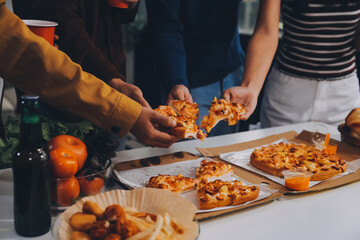 Group of young friends eating pizza.Home party.