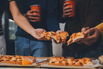 Group of young friends eating pizza.Home party.