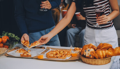 Group of young friends eating pizza.Home party.