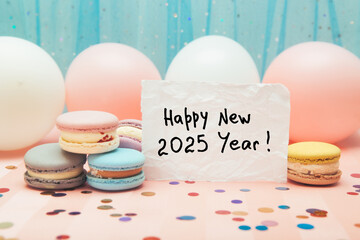 Happy new year 2025 - card with text with pink and white air balloons on light blue background and macarons