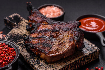 Juicy grilled beef tomahawk steak with salt, spices and herbs