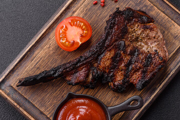 Juicy grilled beef tomahawk steak with salt, spices and herbs