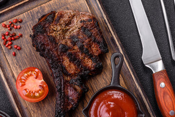 Juicy grilled beef tomahawk steak with salt, spices and herbs