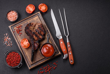 Juicy grilled beef tomahawk steak with salt, spices and herbs