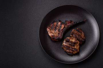 Juicy grilled beef tomahawk steak with salt, spices and herbs
