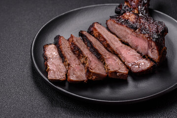 Juicy grilled beef tomahawk steak with salt, spices and herbs