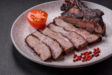 Juicy grilled beef tomahawk steak with salt, spices and herbs