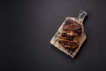Fresh juicy delicious beef steak on a dark background