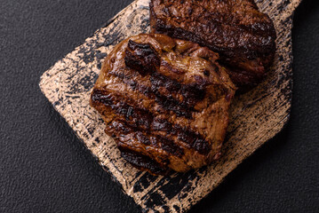 Fresh juicy delicious beef steak on a dark background