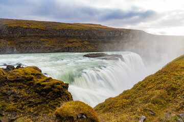 Majestic Gullfoss waterfall route. Icelandic mountain nature landscape. Waterfall landscape. Nature wildness. Iceland waterfall travel destination. Picturesque Gullfoss waterfall. Travel to Iceland