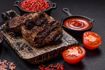 Fresh juicy delicious beef steak on a dark background