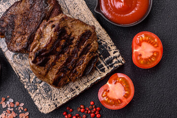 Fresh juicy delicious beef steak on a dark background