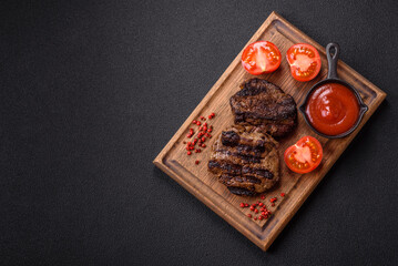 Fresh juicy delicious beef steak on a dark background