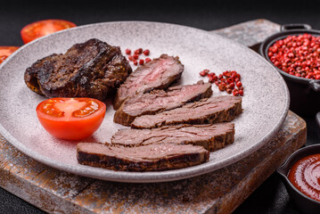 Fresh juicy delicious beef steak on a dark background
