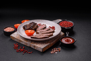 Fresh juicy delicious beef steak on a dark background