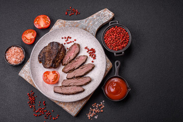 Fresh juicy delicious beef steak on a dark background