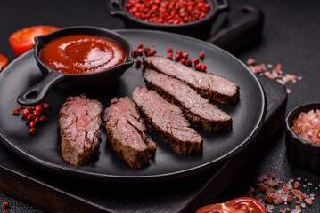 Fresh juicy delicious beef steak on a dark background