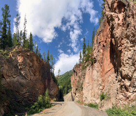gorge Red gate in mountains under large clouds