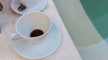 Morning Coffee Cup by Tranquil Poolside Setting