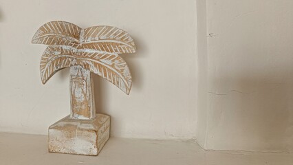 Rustic Palm Tree Sculpture Against Minimalist Wall