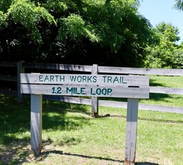 A close view of the old wood trail sign in the park.