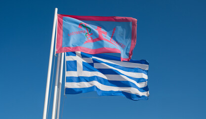 Greece. Greek flag and the flag of the island of Spetses during the 1821 Greek Revolution waving on blue sky