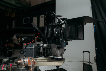 Professional cinema and video camera on the set. Shooting shift, lighting fixtures, shooting equipment and the team.