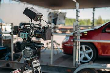 Fototapeta premium Professional film and video camera on the set. Shooting shift, equipment and group.