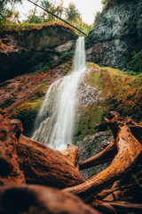 Cascading Waterfall in a Mossy Gorge