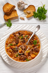 beef barley soup in a bowl, top view