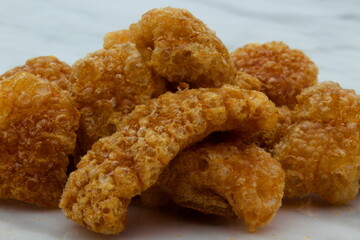Homemade pork rinds or chicharrones carnudos in Spanish, easy to make in a kitchen pan. They are crunchy, meaty and delicious.