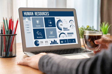 Human resources management software on computer screen helping human resources employee to manage...