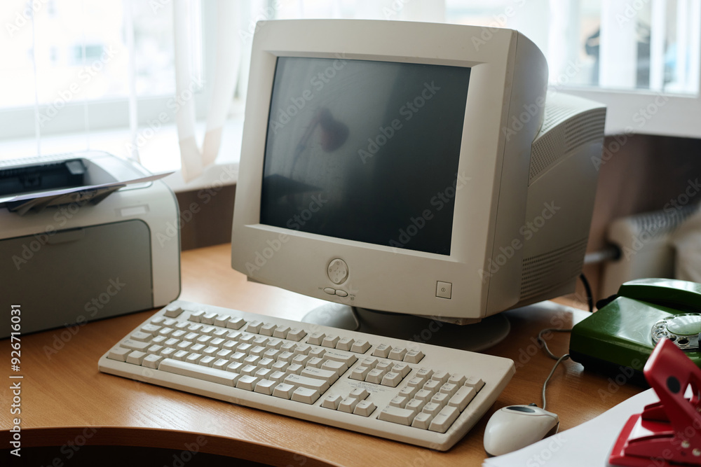 Wall mural vintage computer setup including crt monitor, keyboard, and printer on wooden desk, creating nostalg