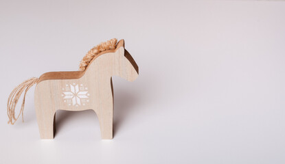 A charming wooden horse toy with a simple design, perfect for rustic or traditional-themed decor and children's projects.