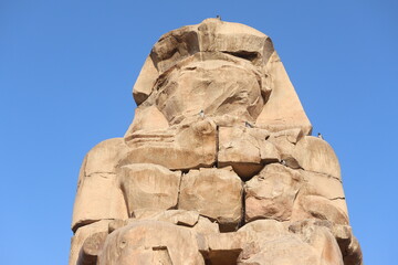 Famous Colossi of Memnon. Massive ruined statues colossi of the Pharaoh Amenhotep III. Travel and...