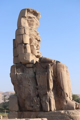 Famous Colossi of Memnon. Massive ruined statues colossi of the Pharaoh Amenhotep III. Travel and...