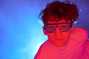 Person with innovative futuristic glasses against vibrant neon blue background creating a captivating and futuristic atmosphere with glowing light that enhances overall visual impact