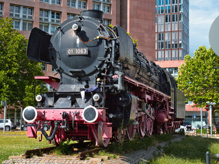 Obraz premium old steam locomotive, which is black and red and stands at the main station in Braunschweig as a museum piece