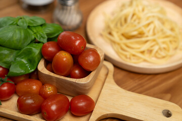 Health food's recipe ingredients of special menu homemade cooking sauce with tomato and basil of macro photo shooting placing elements on preparing wooden table surround blurred background. Postulate.