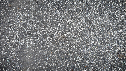 High-resolution 4K texture of asphalt road surface with small stones. Ideal for realistic backgrounds, construction materials, and urban designs