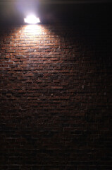 brick wall facade under flood light at night
