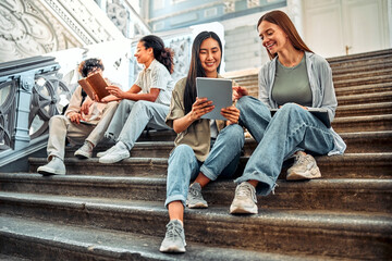 Fototapeta premium Students sit on the stairs and prepare for lessons. Student life.