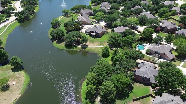 Upscale lakeside houses with mature trees cover, swimming pool in urban sprawl homeowner association at Keller, Tarrant County, suburbs Dallas Fort Worth, upscale two-story homes, flyover view