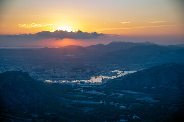 Fototapeta premium View from above of the coast of Cartagena, Region of Murcia, Spain, at dawn with the city's port as the protagonist