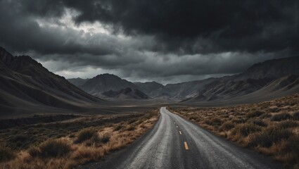 Lonely road through vast mountainous landscape under stormy skies
