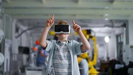 Video of schoolboy with VR headset on head. Children learning robotics in Elementary school, using modern technology, virtual reality. - Powered by Adobe