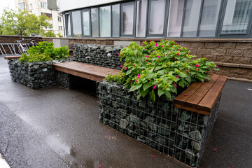 Stylish benches that are beautifully surrounded by lush, vibrant plants significantly enhance urban...