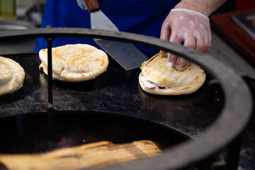 An Artisan Cook Skillfully Preparing Fresh and Delicious Tortillas on a Hot Griddle for Everyone to Enjoy