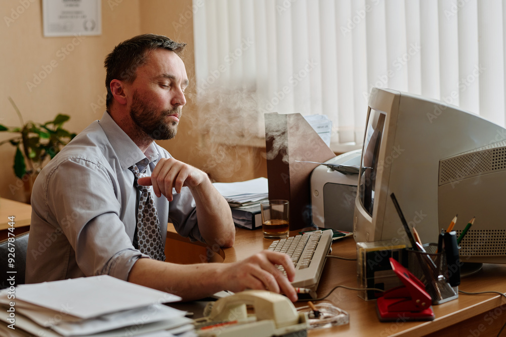 Poster Businessman working in organized office with computer and various devices on desk creating professional environment. Person sitting in thoughtful posture, engaging with work